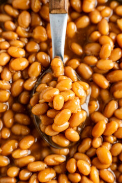 Closeup of baked beans with a spoon 