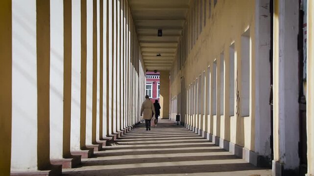People walking in a colonnade in Tambov
