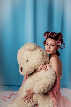 Retro Beauty Prep: Woman with Hair Rollers and Teddy Bear