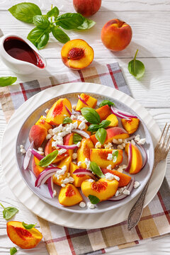 Fresh peach salad with goat cheese on a plate
