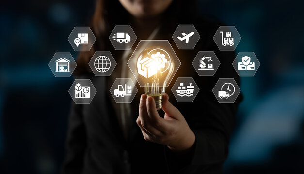 A businesswoman presents a glowing light bulb symbolizing innovative ideas and logistics solutions amid a modern digital backdrop, emphasizing creativity and strategic planning. Ledger
