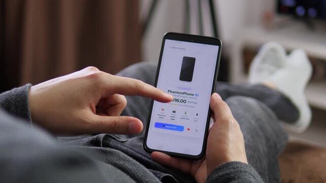 Shopper compares smartphone specifications and a discounted price in a mobile store, highlighting online retail, consumer technology and digital purchasing decisions.