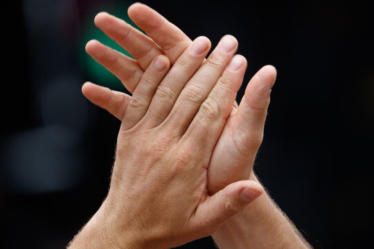 Close-up of two hands clapping together