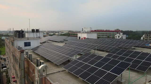 Aerial View of Rooftop Solar Panels on Industrial Factory for Renewable Energy and Sustainable Manufacturing. Industrial Rooftop Solar