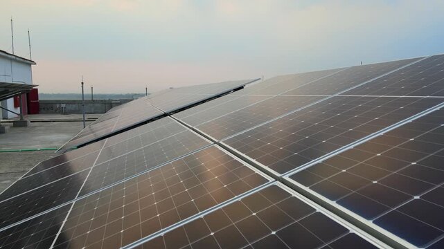 Push Forward Drone Shot Over Rooftop Solar Panels for Renewable Energy and Sustainable Power. Industrial Rooftop Solar