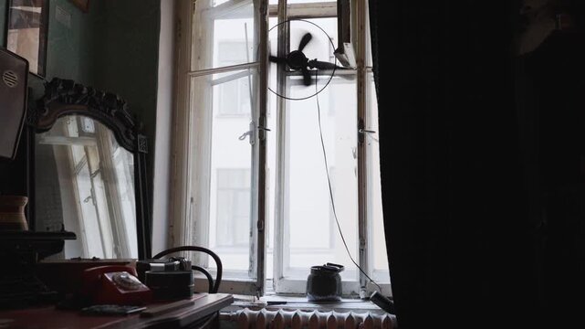 Spinning fan ventilating an old soviet apartment
