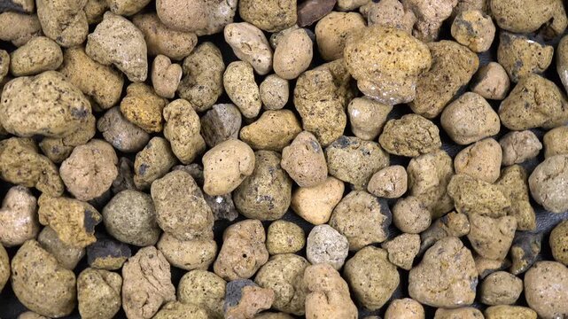 Clay balls as a drainage. Drainage materials for a potted houseplant, top view, background