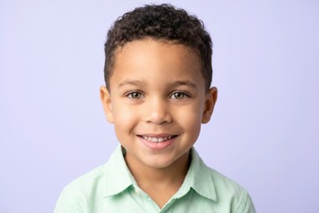 Naklejka premium Cute little boy smiling portrait studio shot with purple background