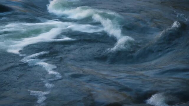 Close-up of swirling water vortex created by river current