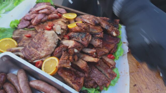 Chef Preparing a Taiwanese Barbecue Meat Platter with Roasted Pork, Sausages and Alfalfa Sprouts