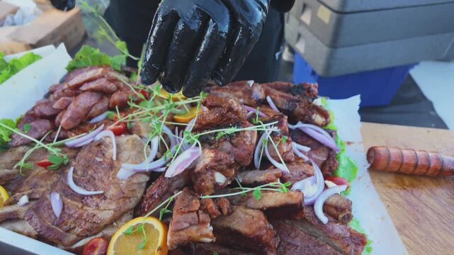 Chef Preparing a Taiwanese Barbecue Meat Platter with Roasted Pork, Sausages and Alfalfa Sprouts