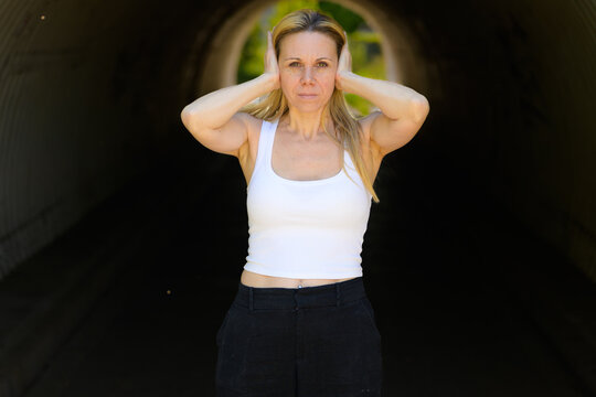 Serious Woman Covering Her Ears