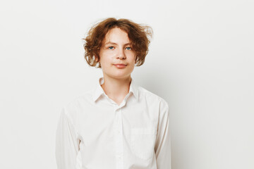 Fototapeta premium Professional young man stands against a solid colored background, exuding calm confidence in a clean, isolated studio setting that emphasizes a business vibe.