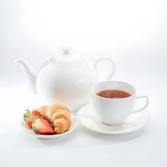 Fototapeta premium Freshly baked cinnamon rolls with coffee on white table.