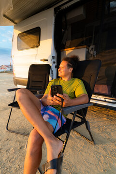 Latin man relaxes outside motorhome on Ecuadorian coast