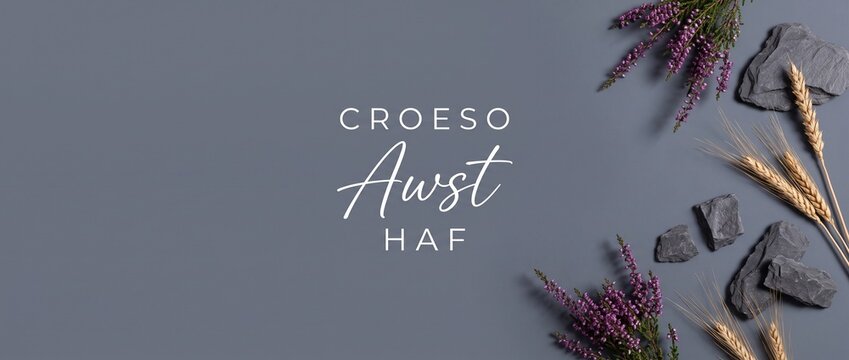Welsh August summer flat lay background with heather, wheat, and slate featuring Croeso Awst Haf text for minimalist top view banner frame layout with copy space for seasonal aesthetic design.