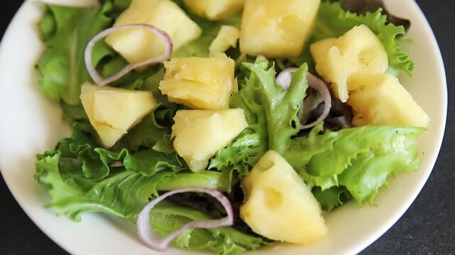 Pineapple Salad mixed green salad leaves and pineapple chunks food preparation tasty snack fresh gourmet food background on the table rustic food top view copy space keto and paleo diets vegetarian an