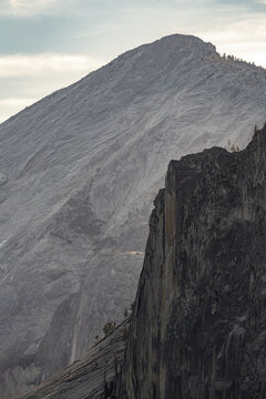 Granite monolith and cliff in Yosemite under cloudy sky