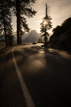 Scenic sunset drive on winding road in Yosemite Valley