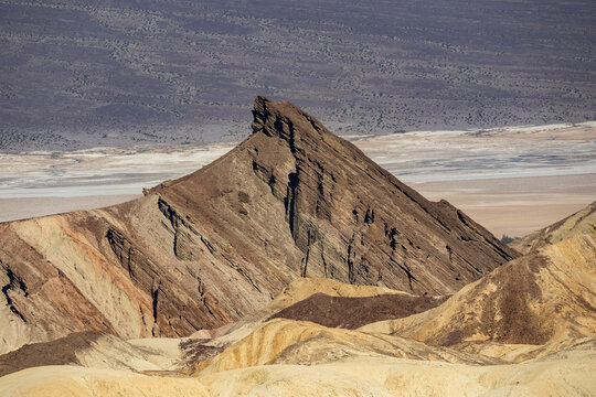 Jagged desert ridge and salt flats in Death Valley