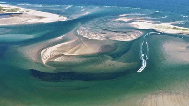 Currents from the Atlantic Ocean continuously shape the sand bars and scenic beaches of Cape Cod, Massachusetts. The entire peninsula is in constant movement due to its geologic makeup of mostly sand.