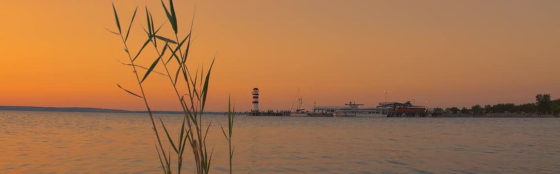 Wide establishing shot, Lake Neusiedl sunset banner, Austria