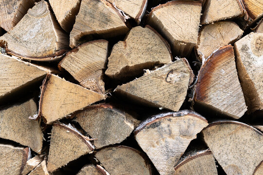 Close-up of stacked split firewood logs in natural light