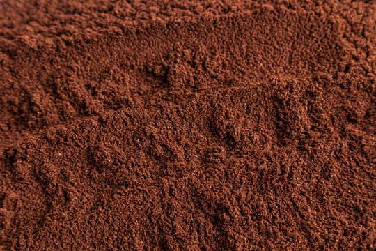 Ground coffee texture background with rich brown granules