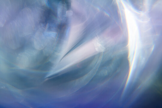 Abstract blue light refraction with iridescent bokeh texture