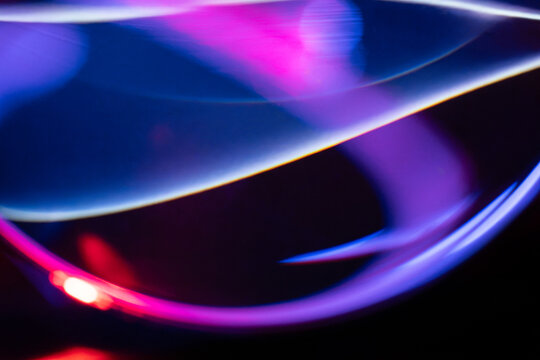 Abstract neon light trail with blue and purple glow