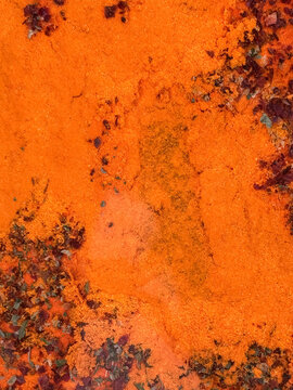 Rusty orange metal surface with peeling weathered texture