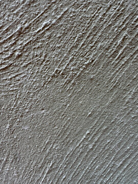 Gray rough concrete wall texture background with diagonal grooves