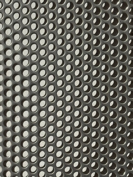 Perforated metal sheet with repeating circular hole pattern
