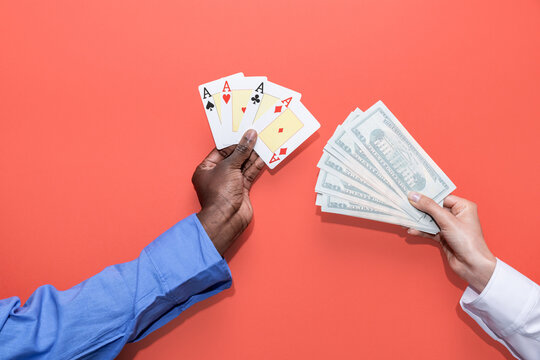 Poker hand and cash wager exchange on coral background.