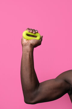 Muscular arm grip strength exercise with yellow hand gripper