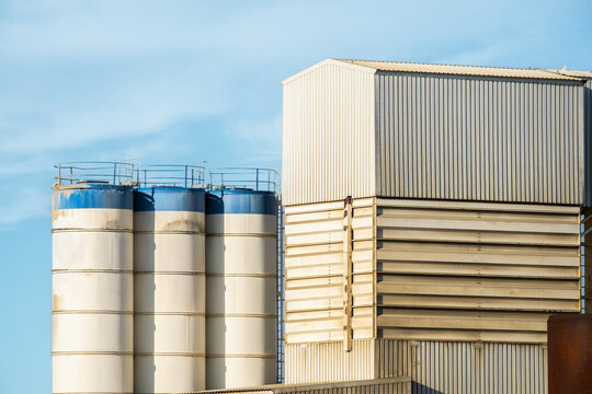Industrial manufacturing factory with silos and warehouse