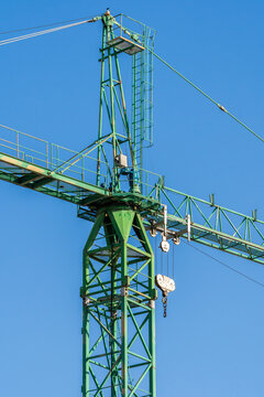 Green crane in industrial construction setting
