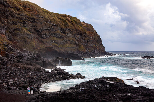 Rocky volcanic coastline and natural bathing cove at Ponta da Ferraria, Sao Miguel Island, Azores, Portugal, overlooking the Atlantic Ocean