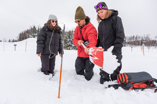 Man shoveling deep snow during avalanche safety course