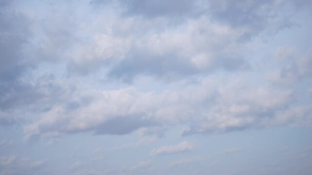 Time lapse video of moving clouds across blue sky, natural atmospheric background for weather, nature and cinematic projects