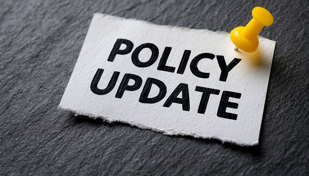 A note pinned to a dark surface with the text policy update written on it. Important business communication concept.