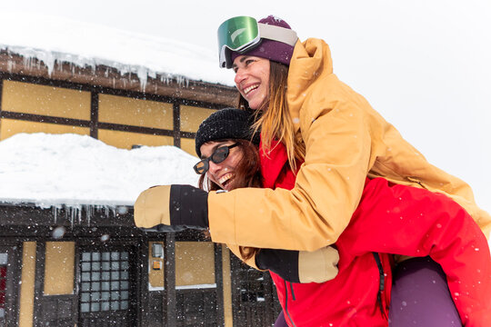 Joyful friends enjoying winter at a Japanese ski resort