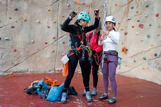 Women climbers prepare for indoor climbing wall training