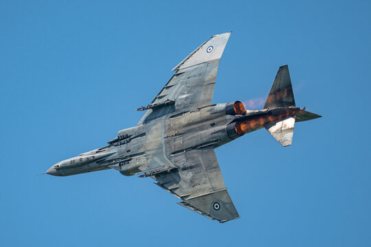 Greek F-4E Phantom Fighter Jet banking hard with afterburner