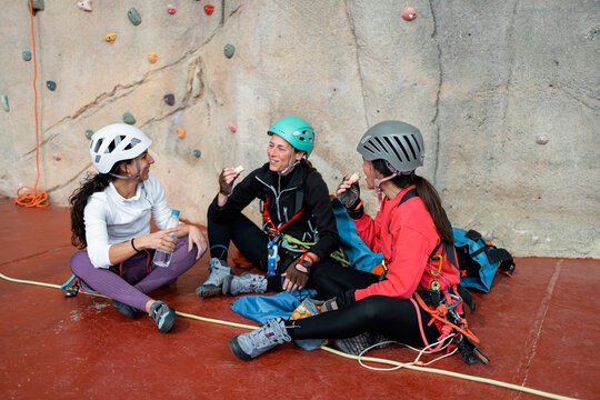 Women climbers take a break during indoor climbing training