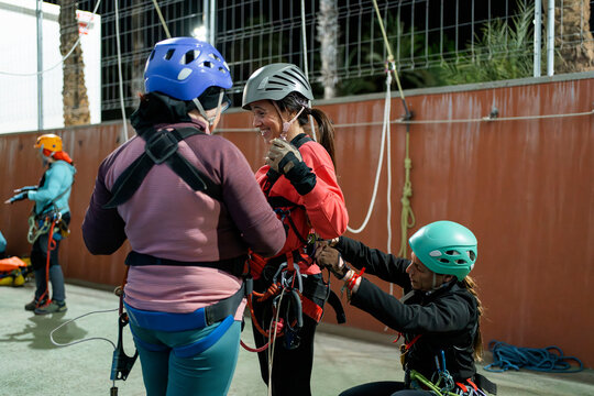 Women prepare for vertical caving training at gym