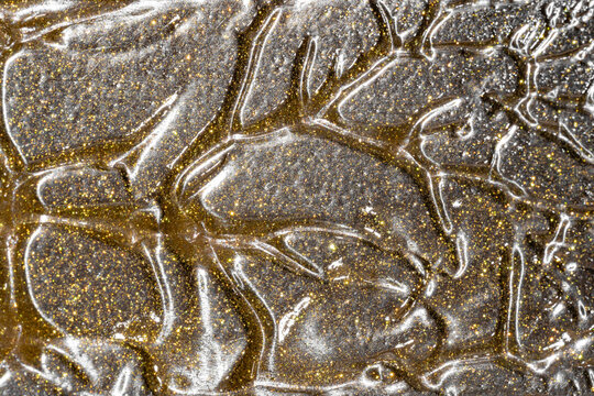 Gold glitter cosmetic smear texture with metallic shine