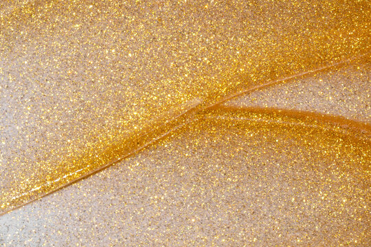 Gold cosmetic smear with glitter texture background