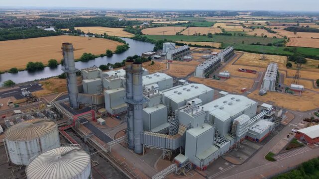 Aerial view of CCGT gas fired power station showing induced draft cooling towers and River Trent near Newark