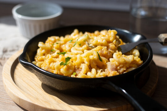 Traditional American mac and cheese pasta in cast iron skillet